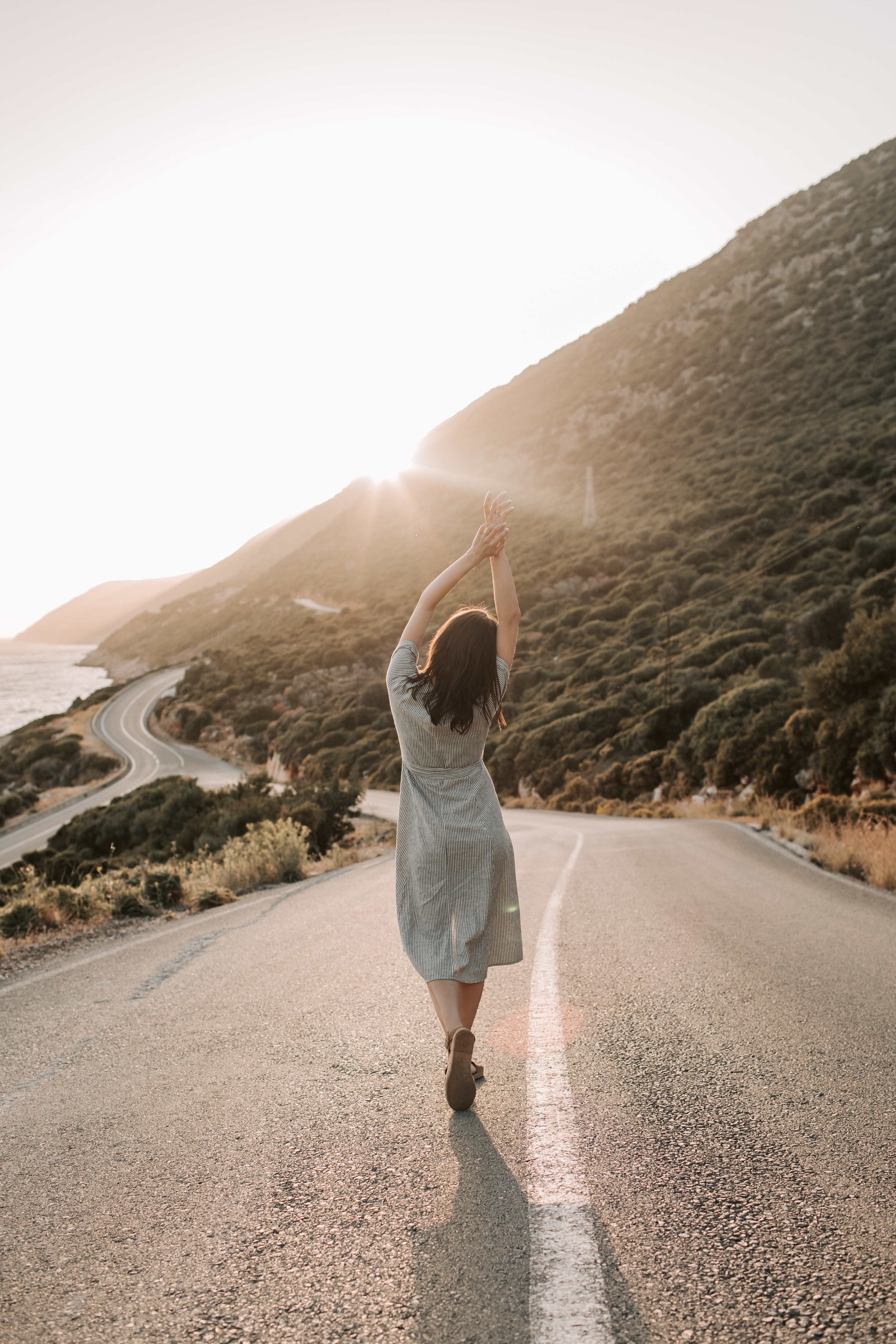 Woman Standing In The Middle Of A Road Feeling Free